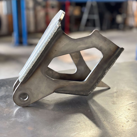 close up of a 4th gen dodge diesel trackbar bracket to replace factory 